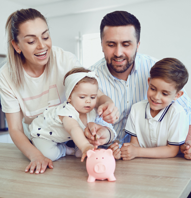 family putting coins into piggy bank