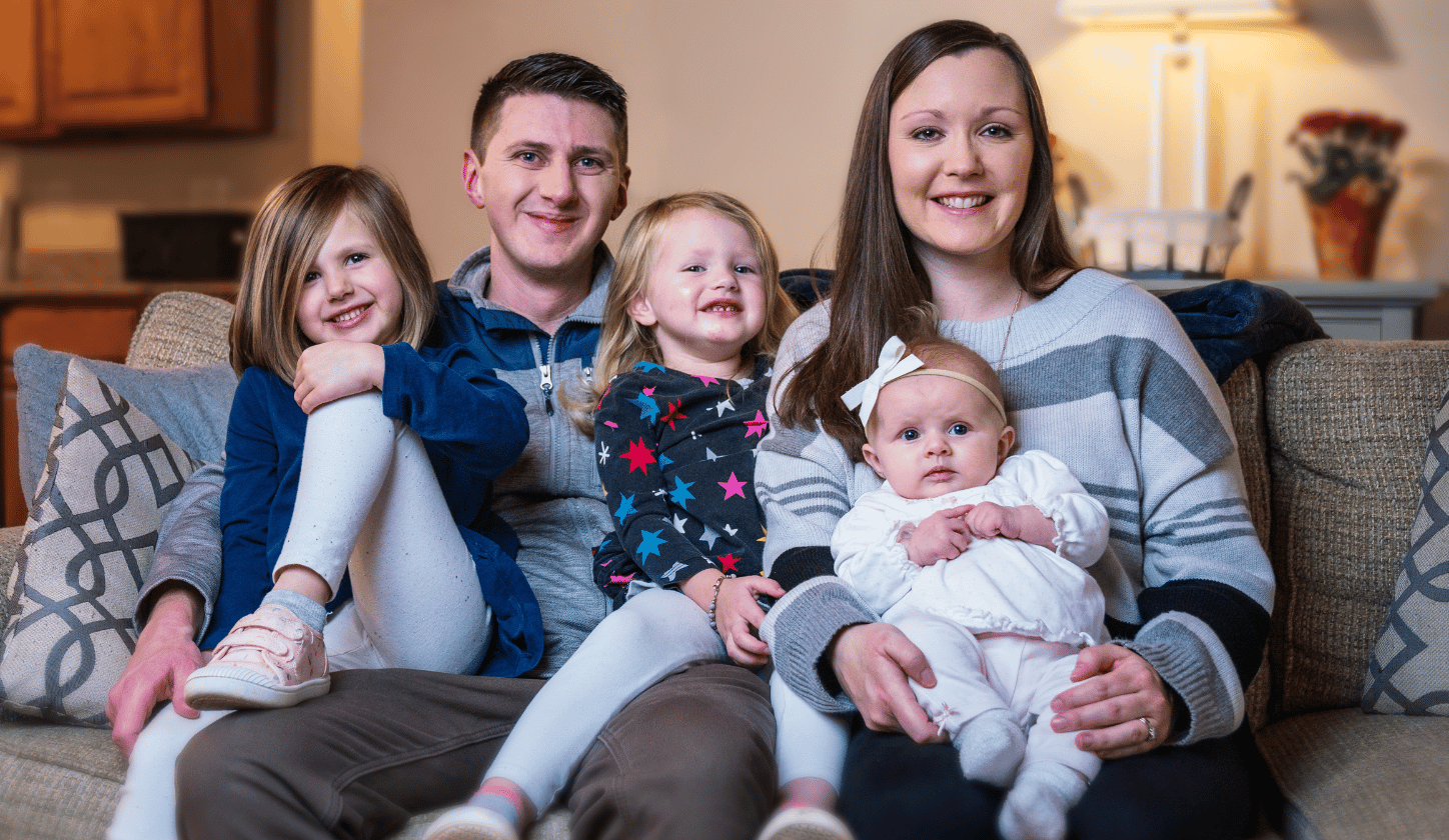 Family sitting on couch together