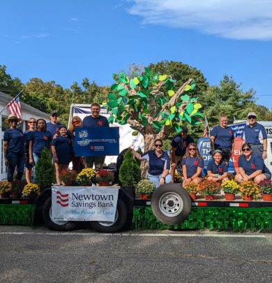 Employees and families standing on labor day parade float