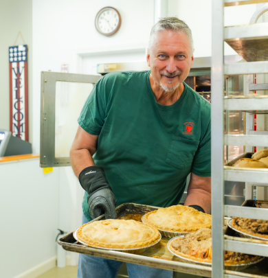 Dan Beardsley taking pies out of oven