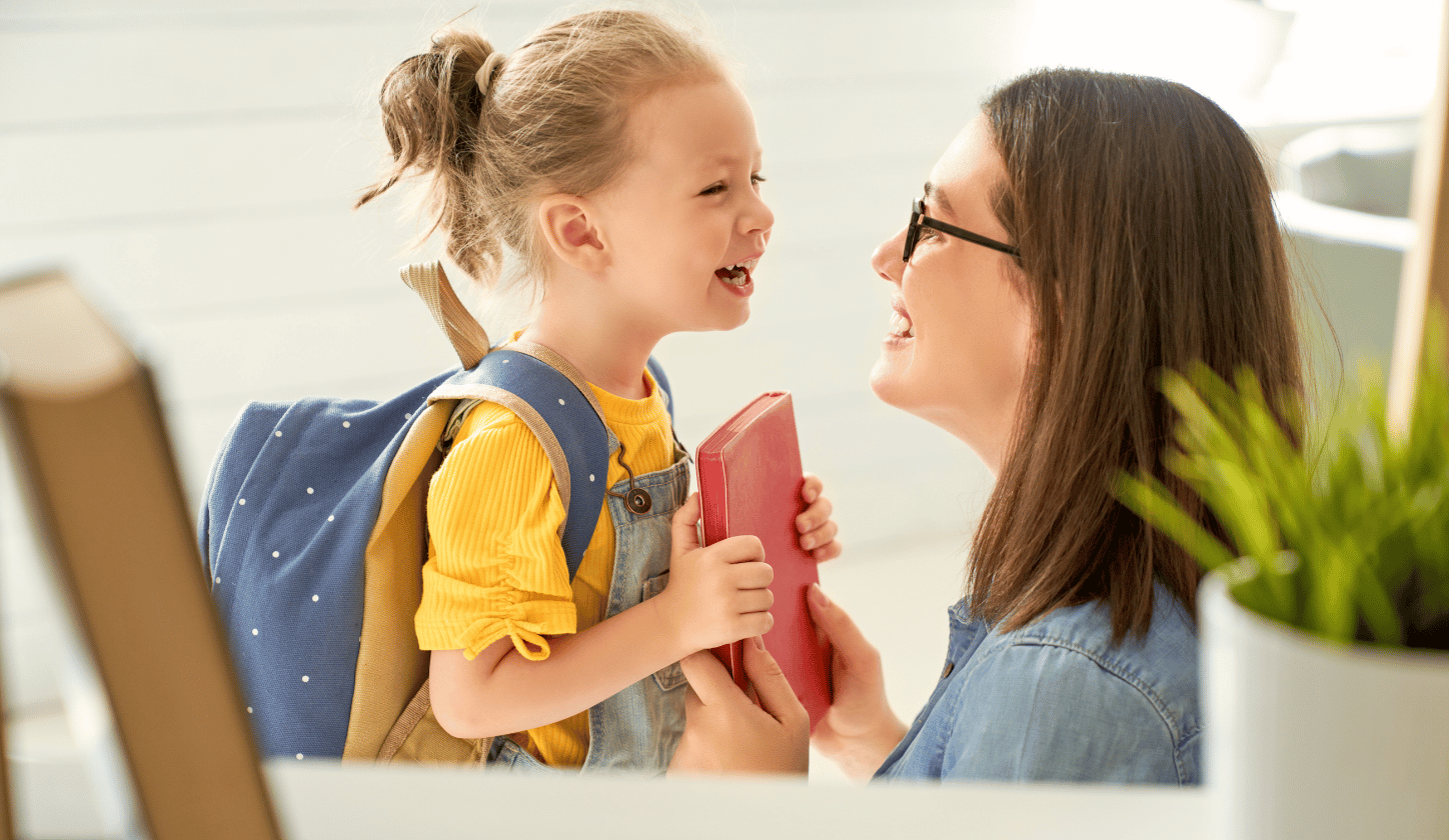 Daughter with backpack and mom smiling