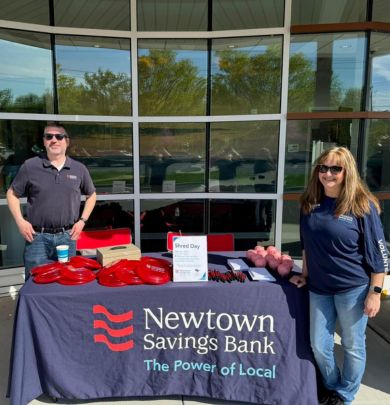 Two employees at NSB table handing out promo items