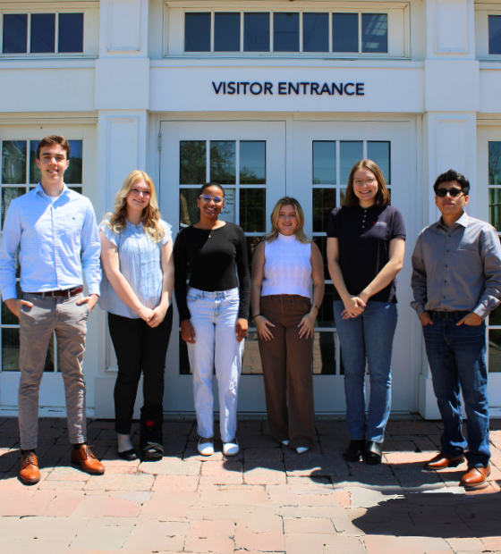 group of interns standing outside employee entrance