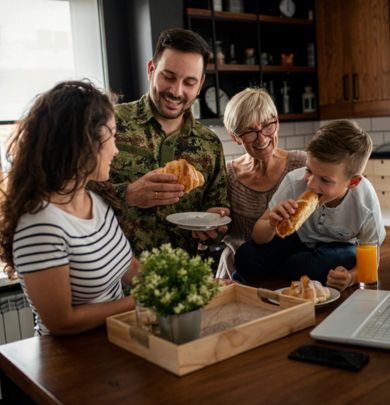 Family eating around table with veteran 
