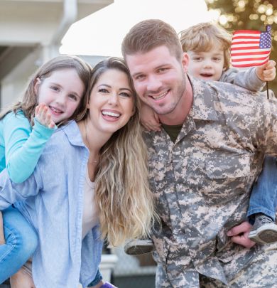 Military dad with family outside of home