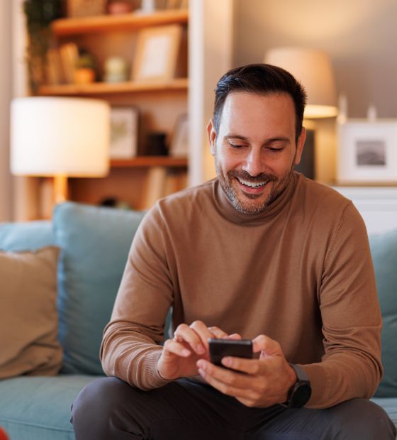 Man on the couch looking at his phone