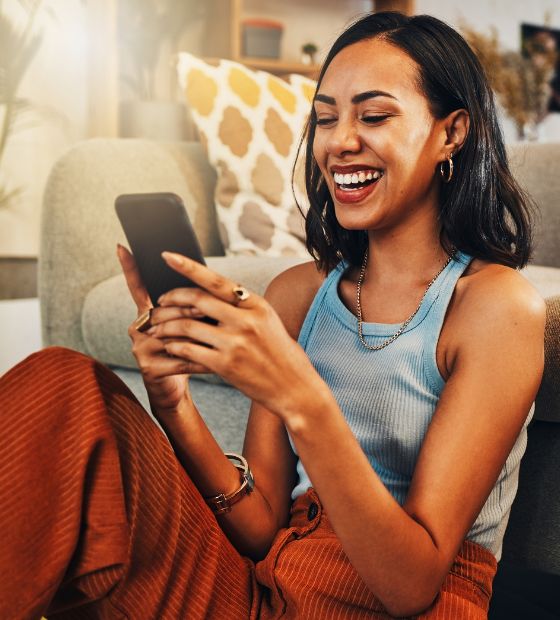 Woman looking at her phone and smiling